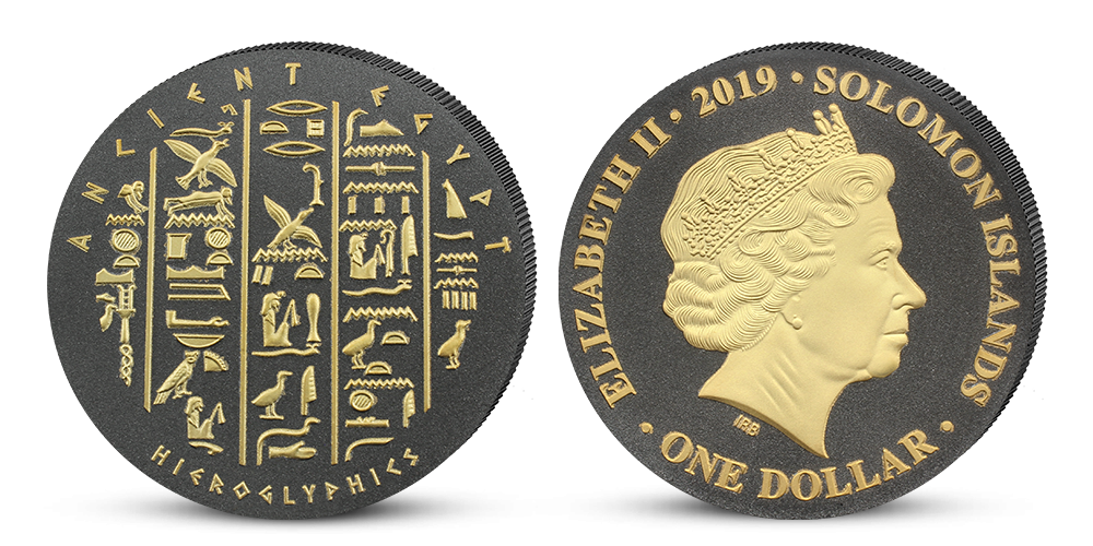 Minca s egyptskými hieroglyfmi v parciálnom zušľachtení rýdzim zlatom a čiernym niklom